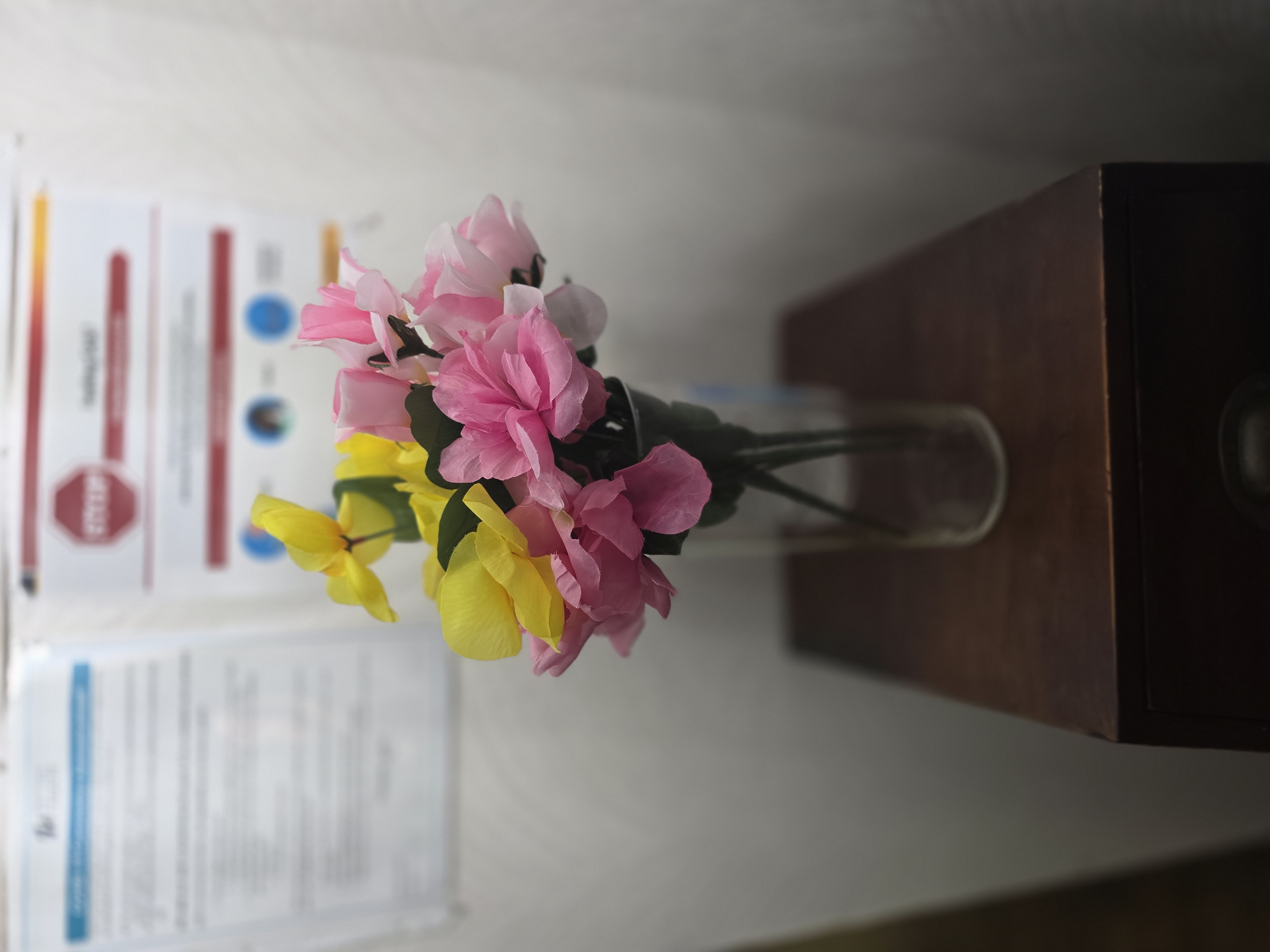 An elderly man in a wheelchair and a nurse, enjoying holistic senior care in Snohomish County, look at a tablet together outside on a patio.